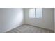 Bright bedroom featuring neutral tones and a window for natural light at 10980 Ampus Pl, Las Vegas, NV 89141