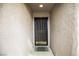 Welcoming front entrance showcasing a decorative security door and textured walls, leading into a cozy home at 10980 Ampus Pl, Las Vegas, NV 89141