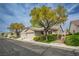 Charming single-story home with two-car garage, lush landscaping, and a well-kept yard in a peaceful neighborhood at 10980 Ampus Pl, Las Vegas, NV 89141