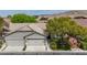 Aerial exterior view of home with desert landscaping, two-car garage, and tile roof at 10980 Ampus Pl, Las Vegas, NV 89141