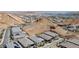 Stunning aerial view of homes nestled in desert landscape with lake views and solar panels at 12 Tatahatso Point St, Henderson, NV 89011