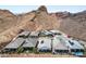 Aerial view of desert homes with pools, solar panels, mountain views, and desert landscaping at 12 Tatahatso Point St, Henderson, NV 89011