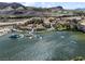 An aerial view capturing the waterfront community, marina, and Venetian-style architecture of Lake Las Vegas at 12 Tatahatso Point St, Henderson, NV 89011