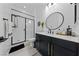 Clean bathroom offers modern vanity, shower, and stylish black and gold accents at 12 Tatahatso Point St, Henderson, NV 89011