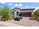 Charming home with a well-manicured front yard and a golf cart parked in the paver driveway at 12 Tatahatso Point St, Henderson, NV 89011