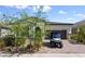 Charming single-story home features a paved driveway and well-manicured landscaping and a golf cart at 12 Tatahatso Point St, Henderson, NV 89011