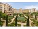 Attractive multi-story building with a landscaped courtyard featuring manicured hedges, shrubs, and trees at 12 Tatahatso Point St, Henderson, NV 89011