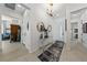 Inviting foyer with modern light fixture, mirror, and console table at 12 Tatahatso Point St, Henderson, NV 89011