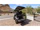 Golf cart parked on paved driveway in front of home features custom seats at 12 Tatahatso Point St, Henderson, NV 89011