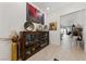 Hallway featuring decorative display cabinet and art, leading to open living area at 12 Tatahatso Point St, Henderson, NV 89011
