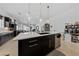 Open kitchen with a large island and modern pendant lighting at 12 Tatahatso Point St, Henderson, NV 89011