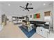 Bright, open-concept living room with hardwood floors, modern furniture, and an abundance of natural light at 12 Tatahatso Point St, Henderson, NV 89011