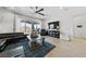 Spacious living room featuring modern design, hardwood floors, and a large TV at 12 Tatahatso Point St, Henderson, NV 89011