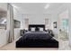 Comfortable main bedroom with neutral walls, hardwood floors, modern furniture, and lots of natural light at 12 Tatahatso Point St, Henderson, NV 89011