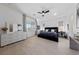 Spacious main bedroom featuring hardwood floors, large windows, and a sleek ceiling fan at 12 Tatahatso Point St, Henderson, NV 89011
