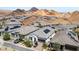 View of upscale desert neighborhood features tile roofs, solar panels and desert mountain views at 12 Tatahatso Point St, Henderson, NV 89011