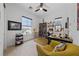 Bright home office features a cozy chair, a ceiling fan and a large window for natural light at 12 Tatahatso Point St, Henderson, NV 89011