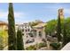 Inviting outdoor patio with stylish furniture, lush landscaping, and elegant architectural details at 12 Tatahatso Point St, Henderson, NV 89011