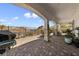 Spacious covered patio with brick pavers, stone pillars, and mountain views, perfect for outdoor entertaining at 12 Tatahatso Point St, Henderson, NV 89011