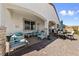 Inviting covered patio with stylish furniture, stone pillars, and brick pavers, ideal for relaxation at 12 Tatahatso Point St, Henderson, NV 89011