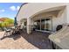 Charming covered patio featuring stone columns, brick pavers, and comfortable seating area at 12 Tatahatso Point St, Henderson, NV 89011