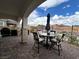 Covered brick patio features an outdoor grill and seating area with mountain views at 12 Tatahatso Point St, Henderson, NV 89011