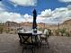Outdoor dining area on a brick patio with desert mountain views at 12 Tatahatso Point St, Henderson, NV 89011