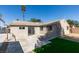 A home backyard with a concrete patio, small grass area and stucco walls, offering private outdoor living at 1304 Virgil St, Las Vegas, NV 89110