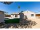 Private backyard features artificial turf, gravel landscaping, and a detached garage at 1304 Virgil St, Las Vegas, NV 89110