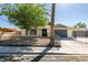 Cozy one-story house featuring a gated yard, desert landscaping, and an attached garage at 1304 Virgil St, Las Vegas, NV 89110