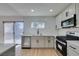 Open kitchen featuring new stainless appliances, breakfast bar and new cabinets at 1304 Virgil St, Las Vegas, NV 89110