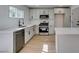 Bright kitchen features stainless steel appliances, white cabinets and quartz countertops at 1304 Virgil St, Las Vegas, NV 89110