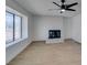 Spacious living room with a fireplace, ceiling fan and large window at 1304 Virgil St, Las Vegas, NV 89110