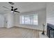 Bright living room featuring wood floors, modern fan, large window, and stylish fireplace at 1304 Virgil St, Las Vegas, NV 89110