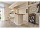 The open wet bar area has counter seating, natural light, and modern fixtures at 1430 October Oak Ave, Las Vegas, NV 89123