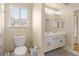 Bathroom with a white dual sink vanity and a white toilet at 1430 October Oak Ave, Las Vegas, NV 89123