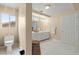 Bright bathroom with dual sinks, white cabinetry, and a separate toilet area at 1430 October Oak Ave, Las Vegas, NV 89123