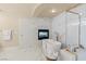Elegant bathroom featuring a soaking tub with fireplace, gold fixtures, and glass-enclosed shower at 1430 October Oak Ave, Las Vegas, NV 89123