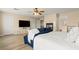 Spacious bedroom with a TV, a seating area, and a bed in the back at 1430 October Oak Ave, Las Vegas, NV 89123