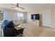 Bedroom featuring a seating area, a TV, and large windows with curtains at 1430 October Oak Ave, Las Vegas, NV 89123