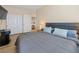 Relaxing bedroom with a gray upholstered headboard and a gray quilt at 1430 October Oak Ave, Las Vegas, NV 89123