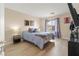 Bright bedroom with natural light, wood-look floors, and a mounted TV for relaxing at 1430 October Oak Ave, Las Vegas, NV 89123
