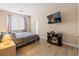 Bright bedroom features wood-look floors, neutral walls, large window and a TV for relaxing at 1430 October Oak Ave, Las Vegas, NV 89123
