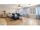 Spacious bedroom featuring natural light, a ceiling fan, and a comfortable seating area at 1430 October Oak Ave, Las Vegas, NV 89123