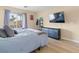 Bright bedroom features wood-look floors, natural light, and a mounted TV for relaxing at 1430 October Oak Ave, Las Vegas, NV 89123