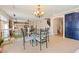 This dining room includes tile flooring, chandelier lighting, and plenty of natural light at 1430 October Oak Ave, Las Vegas, NV 89123
