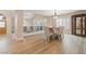 This is a bright dining room with wood floors, a modern light fixture, and seating for four at 1430 October Oak Ave, Las Vegas, NV 89123