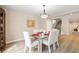 Bright dining area with glass table and seating for six is perfect for entertaining guests at 1430 October Oak Ave, Las Vegas, NV 89123