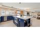 Gourmet kitchen with quartz island, modern light fixtures, stainless appliances and adjacent dining area at 1430 October Oak Ave, Las Vegas, NV 89123