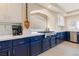 Gourmet kitchen featuring a stainless steel range, marble countertops, and custom blue cabinets at 1430 October Oak Ave, Las Vegas, NV 89123